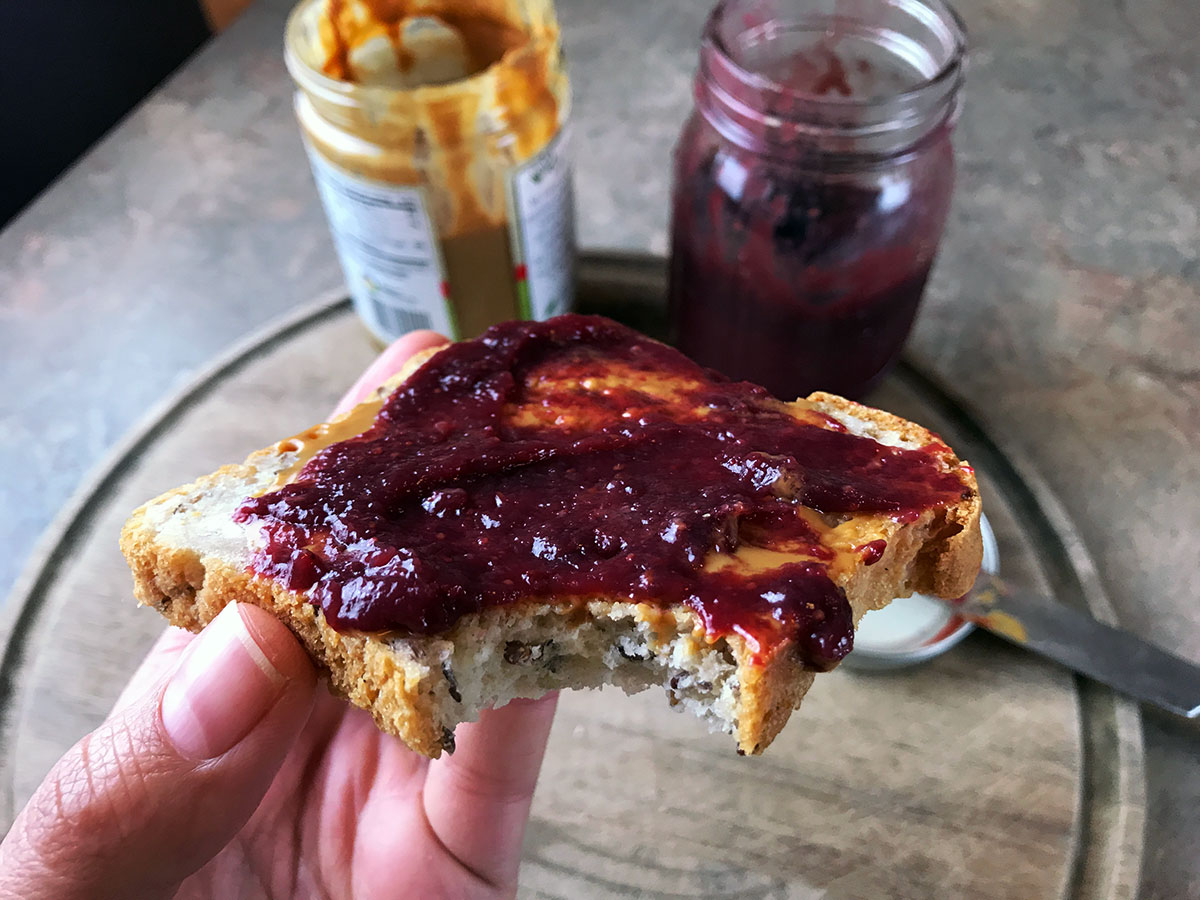 peanut butter and homemade jelly toast with a bite taken out of it