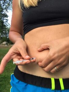 girl with type 1 diabetes giving insulin injection in the stomach
