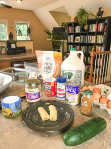 kitchen tools and ingredients needed for cinnamon swirl zucchini bread arranged on kitchen counter